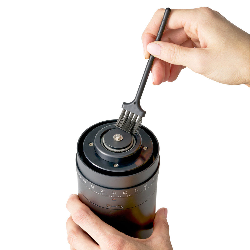 Cleaning the burr on the Avanti rechargeable coffee grinder with its brush