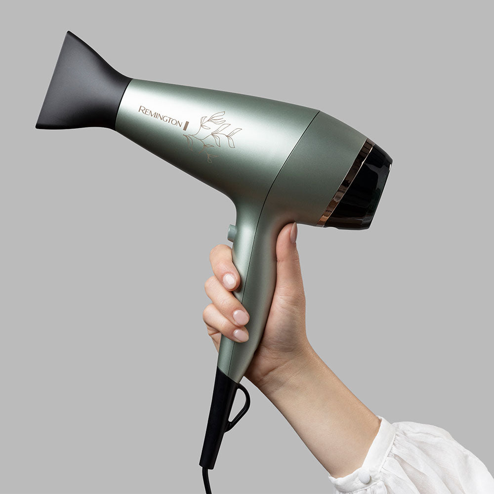 Remington AC5860AU hair dryer with concentrator held in hand